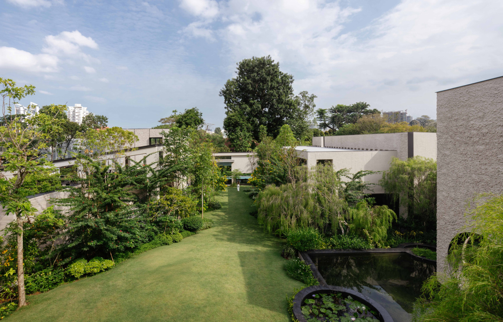 An aerial view reveals the full sweep of the Good Class Bungalow compound, with five pavilions threaded through the landscape by a sheltered outer pathway