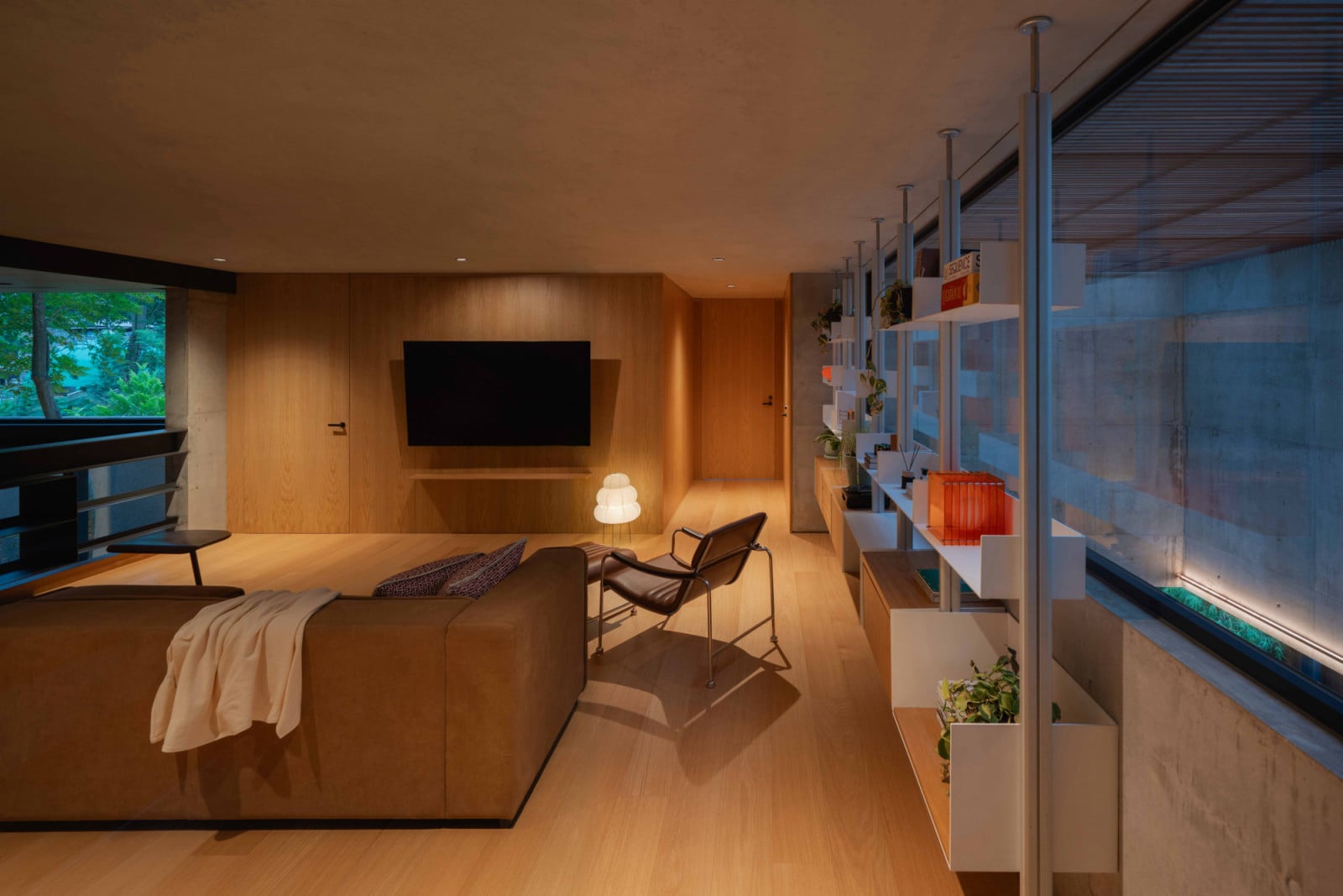 A television, hidden from the garden room below, finds its place instead in the mezzanine's TV lounge