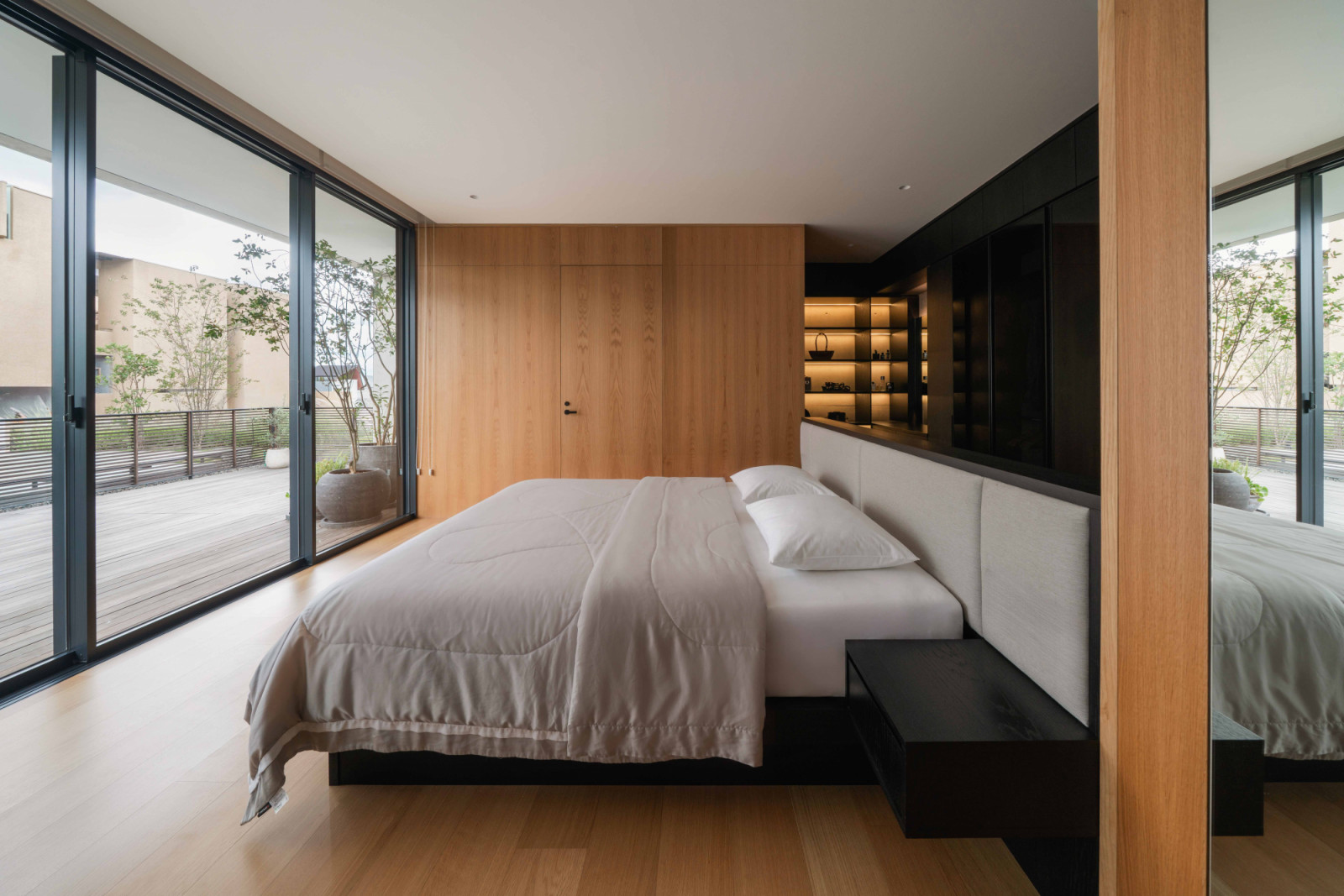 Sliding glass doors along one wall give the master bedroom direct access to its own terrace