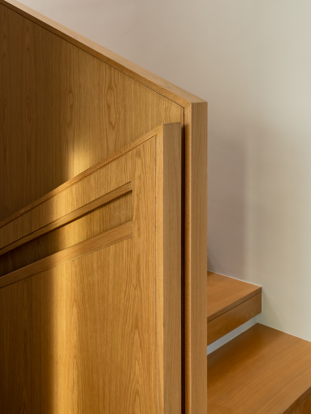 A detail of the staircase balustrade, treated as a timber plane with an integrated handrail