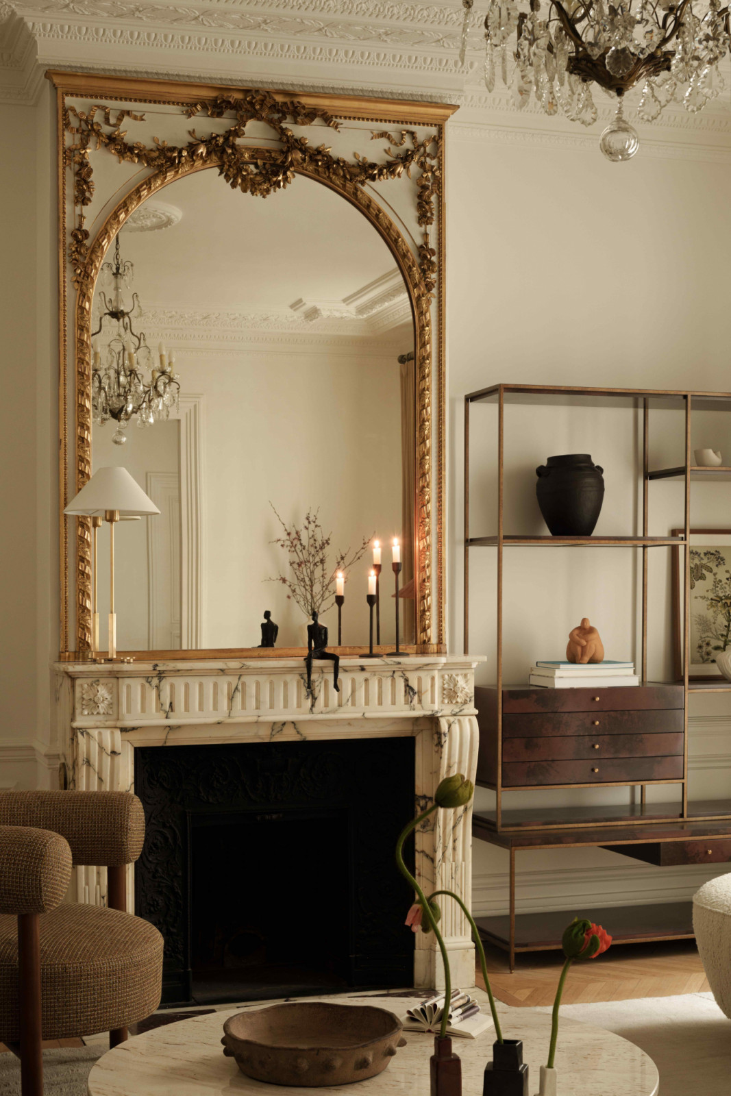A mirror with aged-gold frame from the previous owner sits atop the fireplace