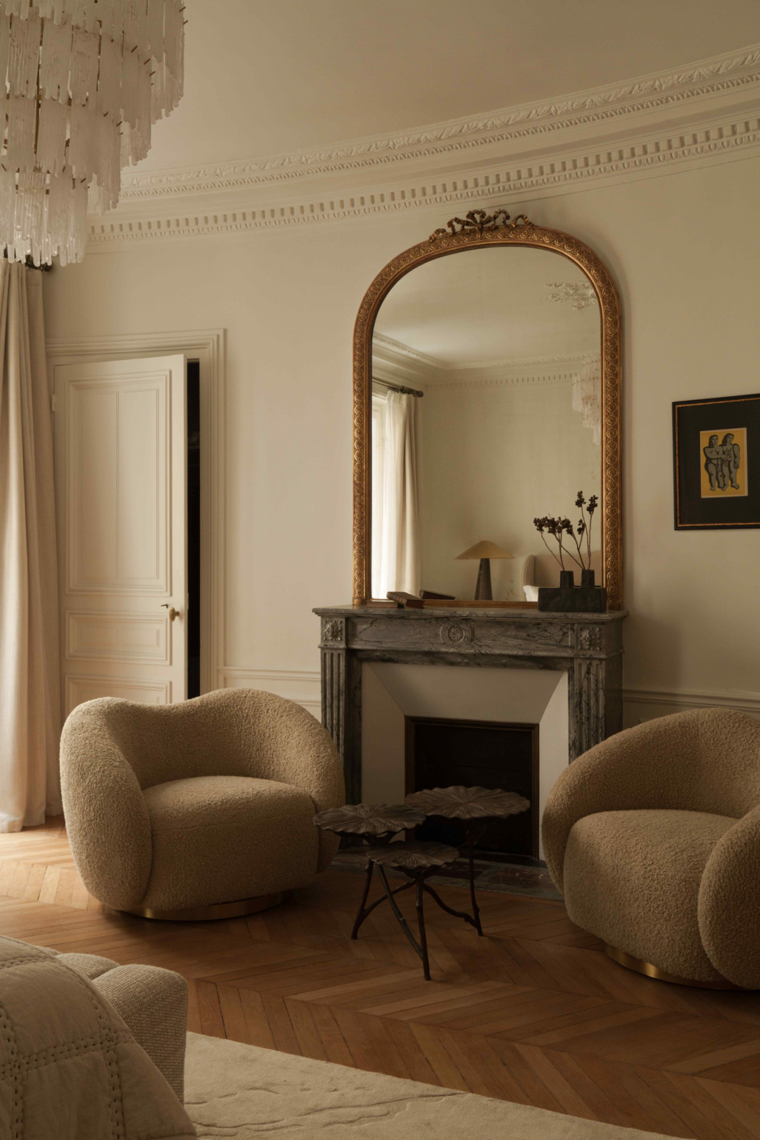 A pair of Diego swivel chairs by Eichholtz situated by the fireplace