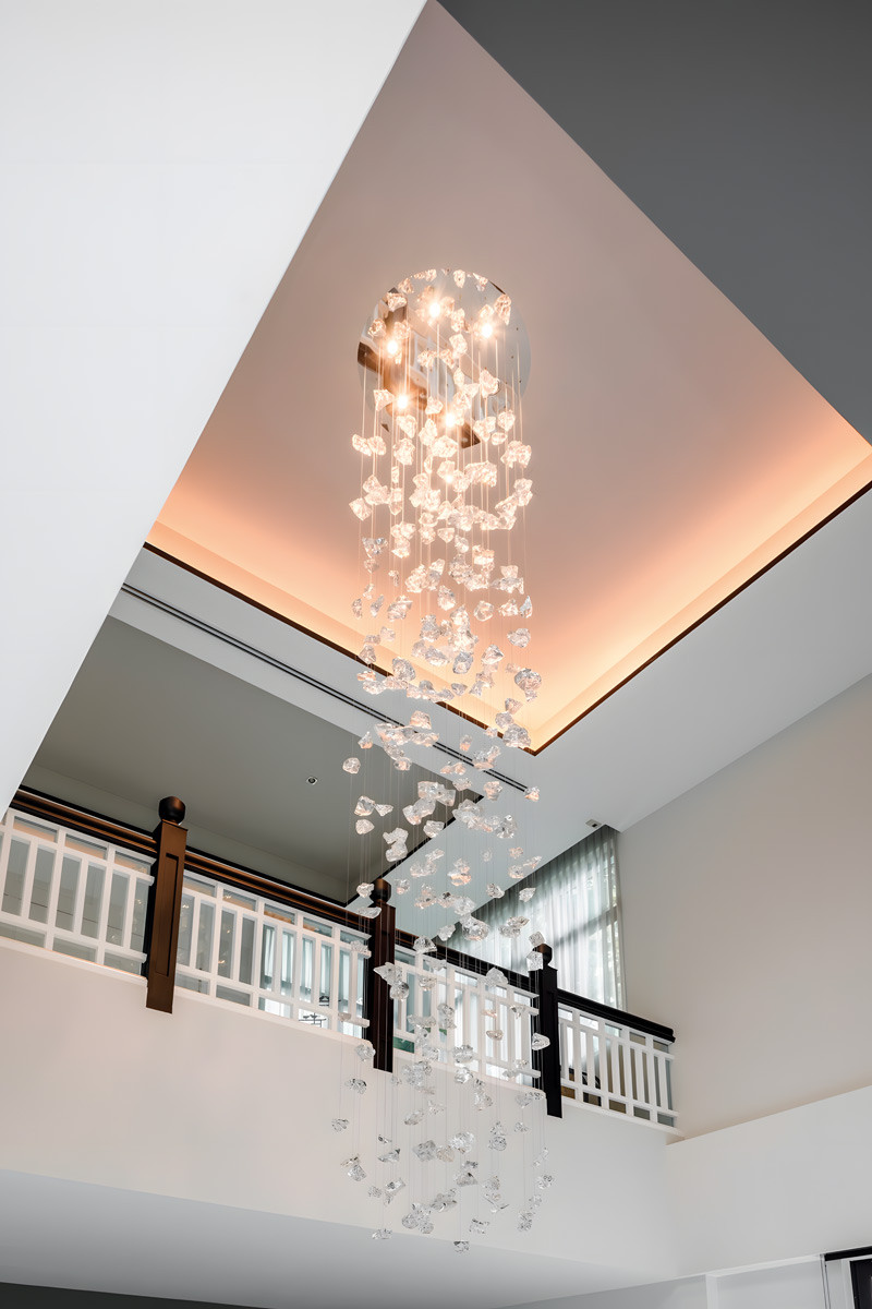 A juxtaposition of new chandelier and black-and-white balustrade