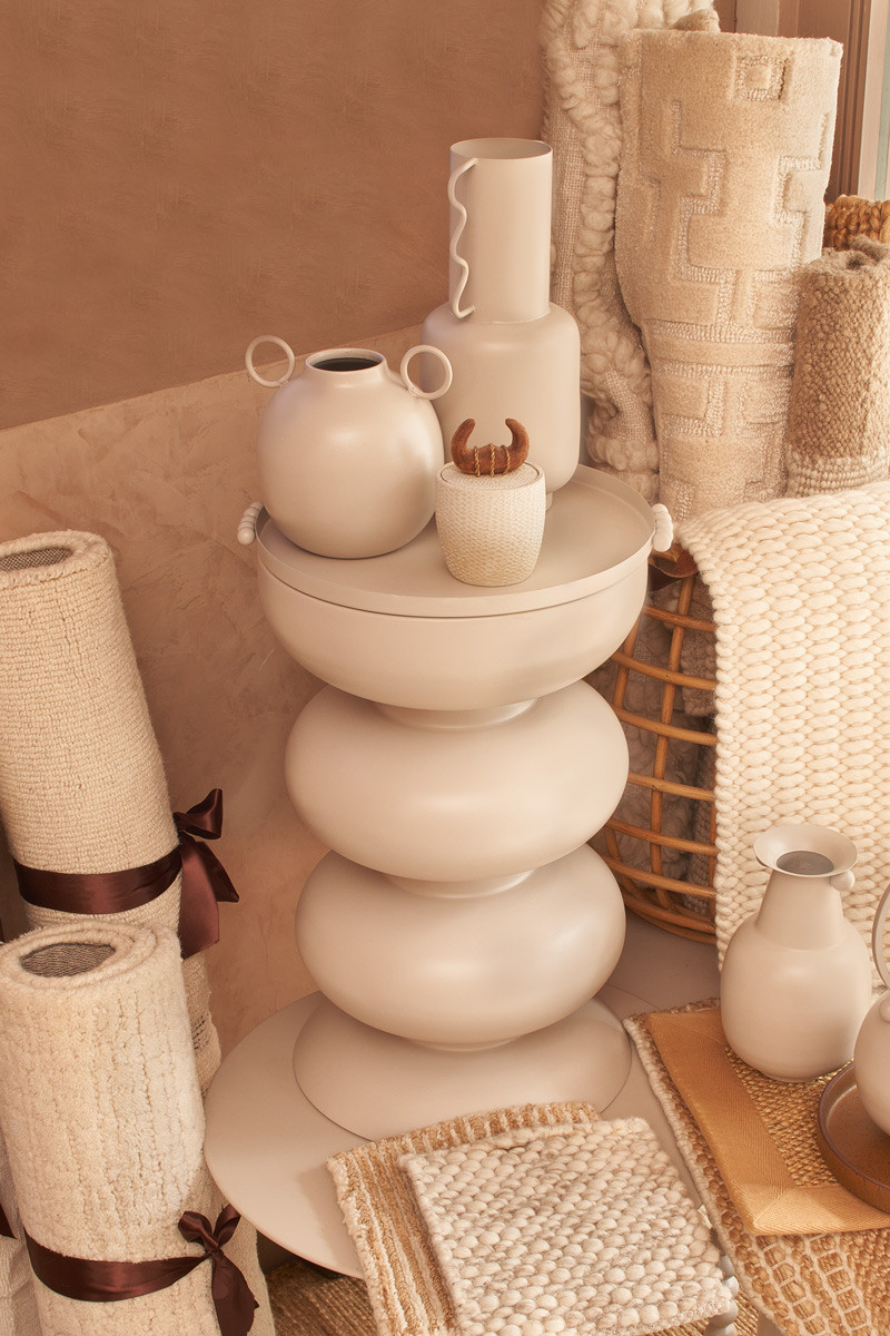 A curated, tactile vignette of vases and rolled rug samples at the Living DNA showroom