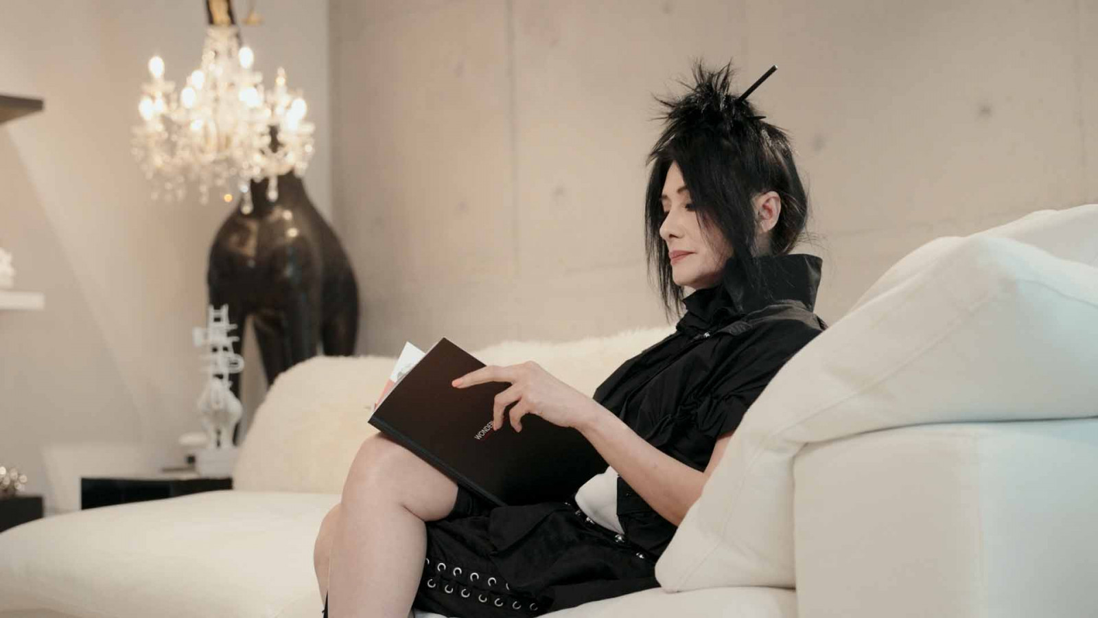 Lim settles into her living room, surrounded by favourite pieces from her collection