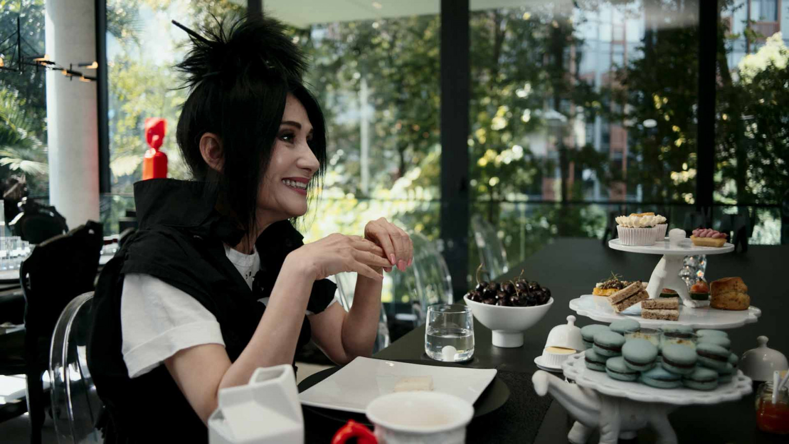 Lim plays host for afternoon tea, trees pressing in on every side