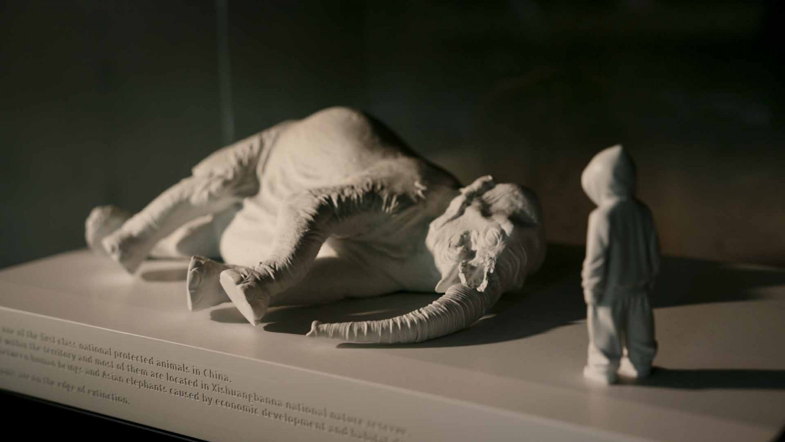 One of Belgian sculptor Daisy Boman's "Bo-men" figures, keeping watch over a fallen elephant