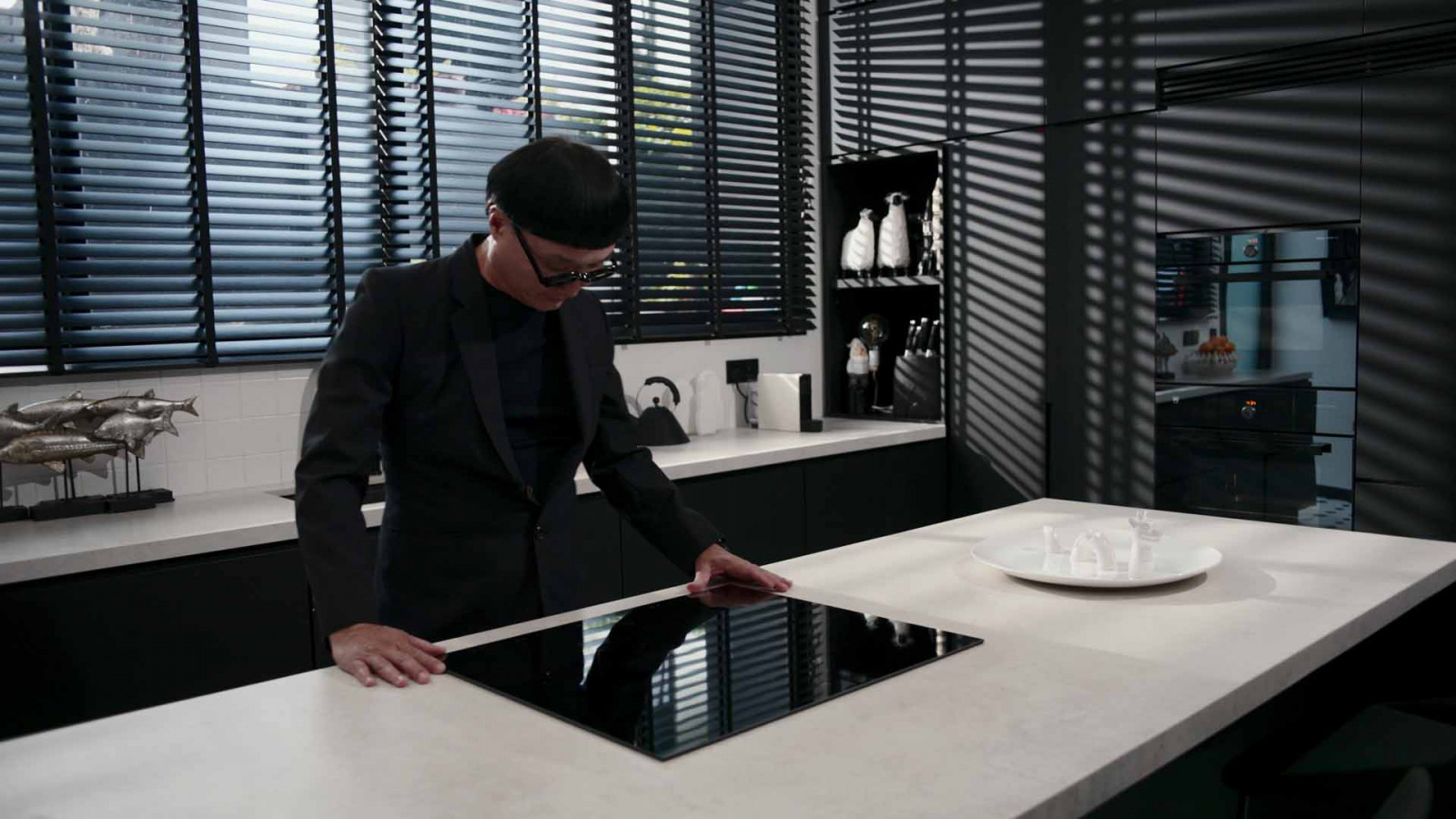 Architect Edmund Ng runs a hand across the V-ZUG induction cooktop