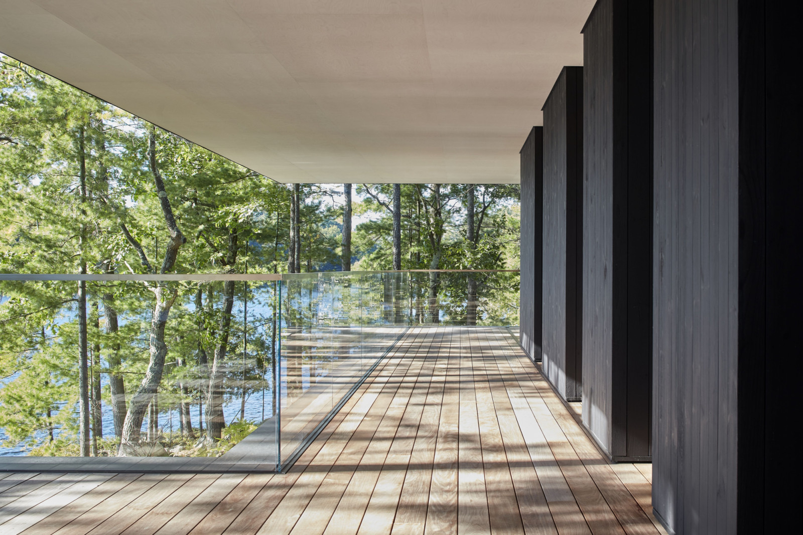 Glass railings surround the wire-brushed Canadian white pine with black cladding