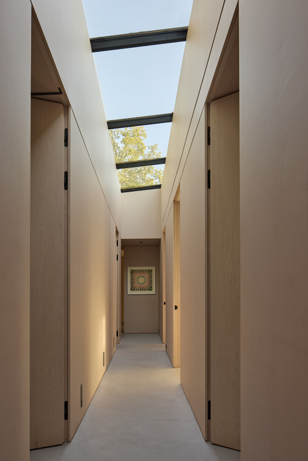 The lofty corridor illuminated by a wall-to-wall skylight
