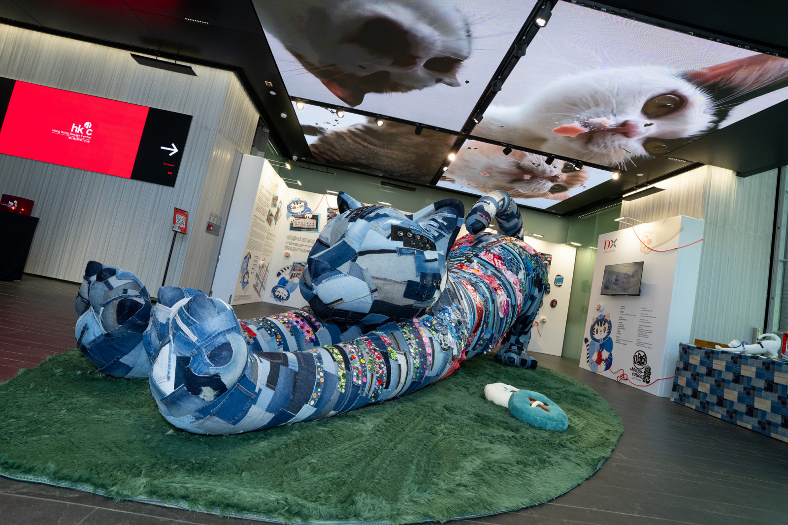 A giant cat installation stitched from local Sham Shui Po textiles headlines the community-driven ‘Meow-cation’ exhibition at DX design hub. (Photo: Hong Kong Design Centre)