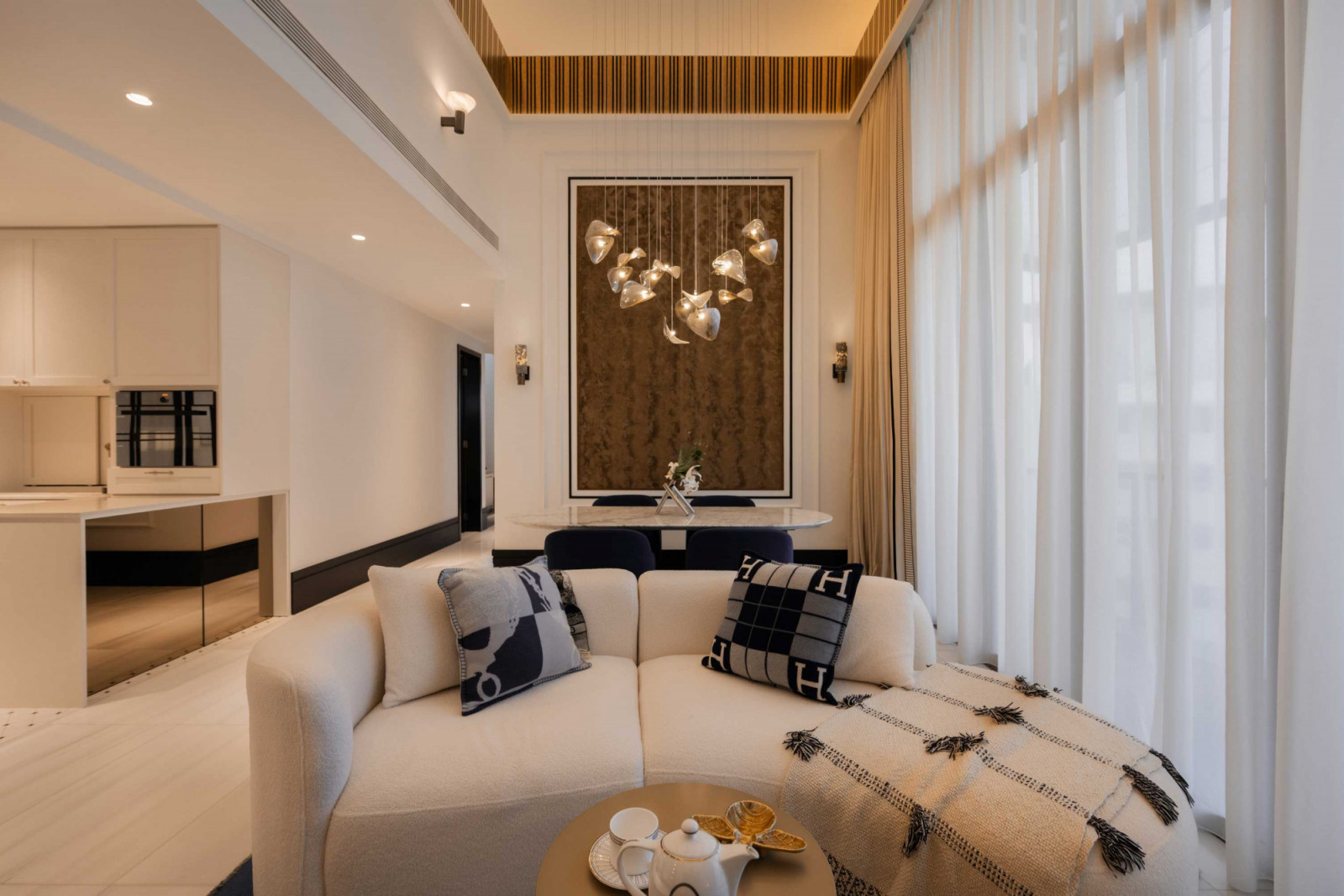 Tactile additions such as fluffy throws and a fuzzy wall hanging bring a warm and relaxed air to the living space