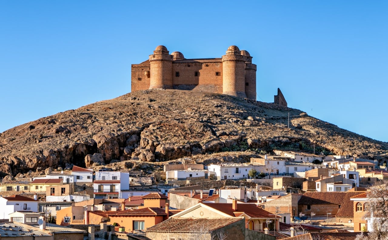Castillo de La Calahorra rises above the village of the same name in Granada, its plain exterior concealing a Renaissance palace within (Photo: iStock)