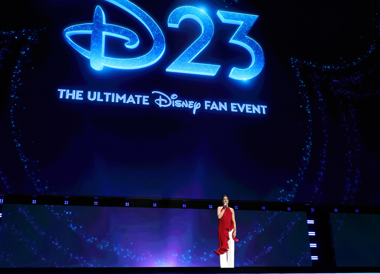 ANAHEIM, CALIFORNIA - AUGUST 14: Anne Hathaway speaks onstage at the Disney Entertainment Showcase at D23: The Ultimate Disney Fan Event on August 14, 2026 in Anaheim, California. (Photo by Jesse Grant/Getty Images for Disney)