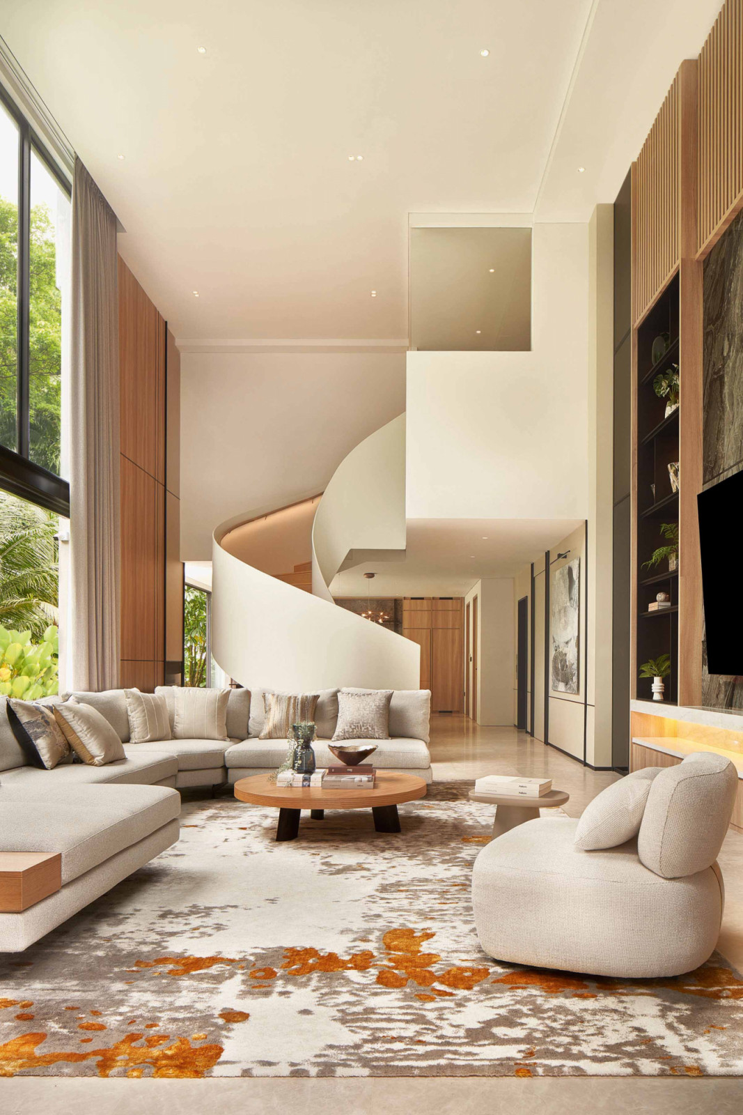 The soaring spiral staircase is a key design feature in the living area of Aurum Land CEO’s family home