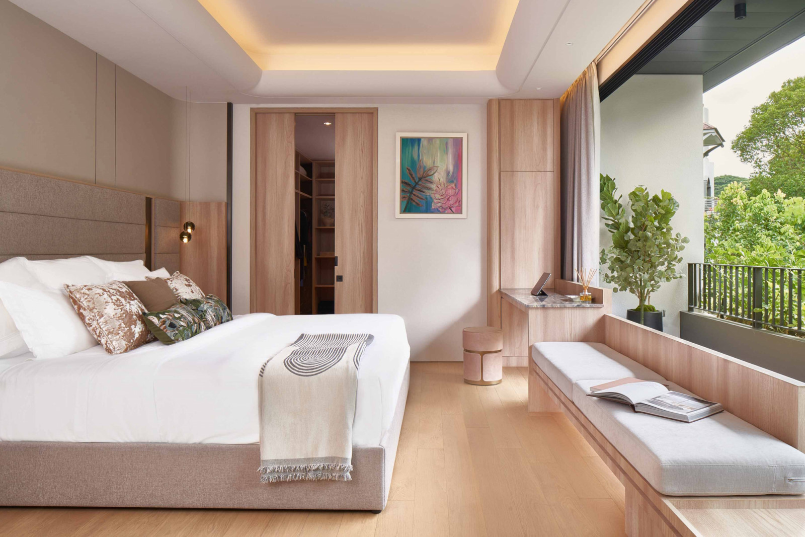 Bench seating enhances the functionality of this bedroom, which is finished in pale timber fittings that evoke a calming atmosphere and increase its biophilic appeal