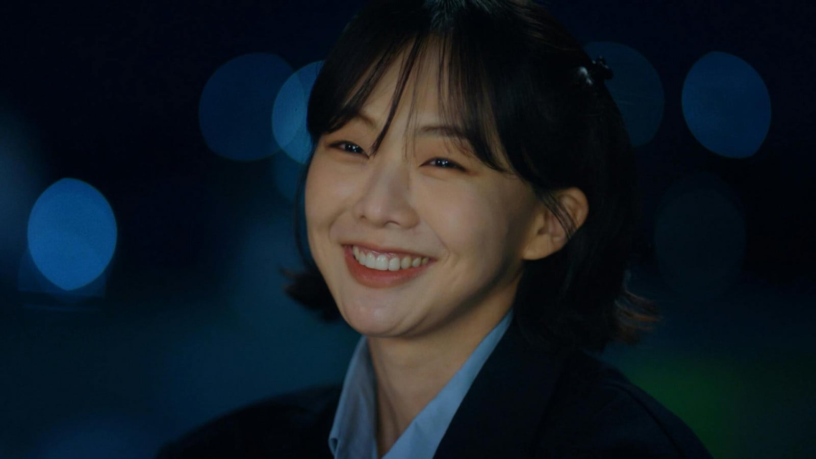 Geum Sae-rok smiling wearing suit at night (Photo: IMDB)