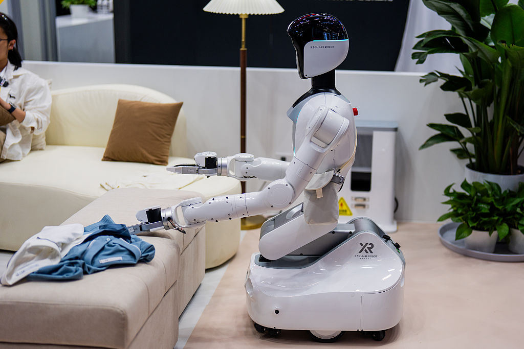 BEIJING, CHINA - AUGUST 20: A humanoid robot folds clothes during the 2026 World Robot Conference on August 20, 2026 in Beijing, China. The conference, which runs from August 19 through August 23, has drawn more than 300 exhibitors from 26 countries, with over 3,000 products on display, including more than 300 debuts. (Photo by VCG/VCG via Getty Images)