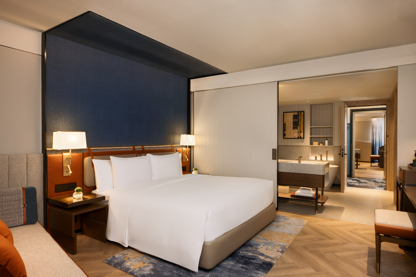 Guest rooms styled with traditional handwoven blue Paa Khram bed canopies and residential finishes. (Photo: Canopy Bangkok Sukhumvit)
