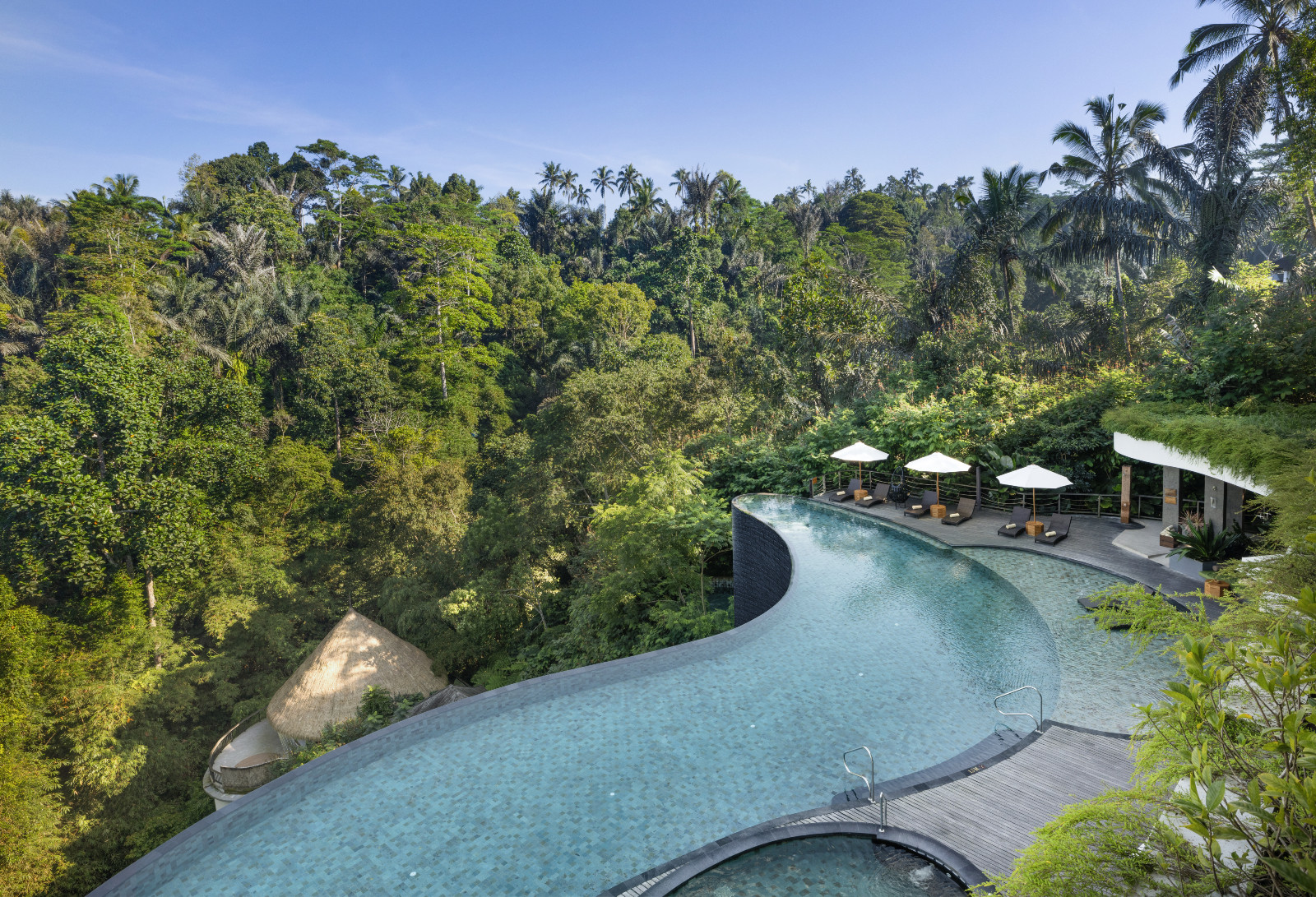 The Cicada resort’s main pool, framed by lush tropical greenery and serviced by the wellness-focused Verdant Pool Lounge & Bar. (Photo: Cicada Resort Bali Ubud)