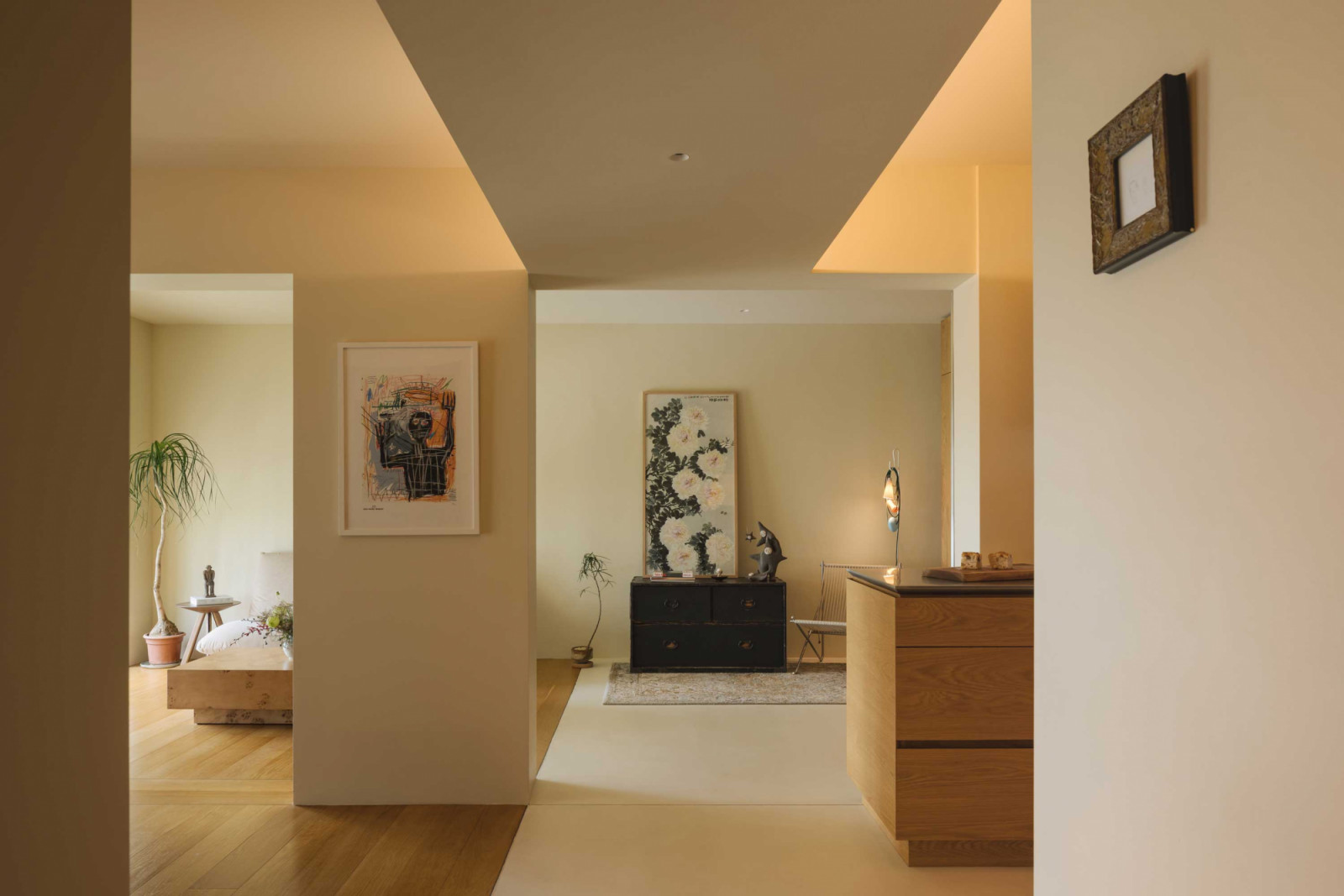 In lieu of conventional partitions and walls, strategic voids connect and demarcate distinct portions of the home
