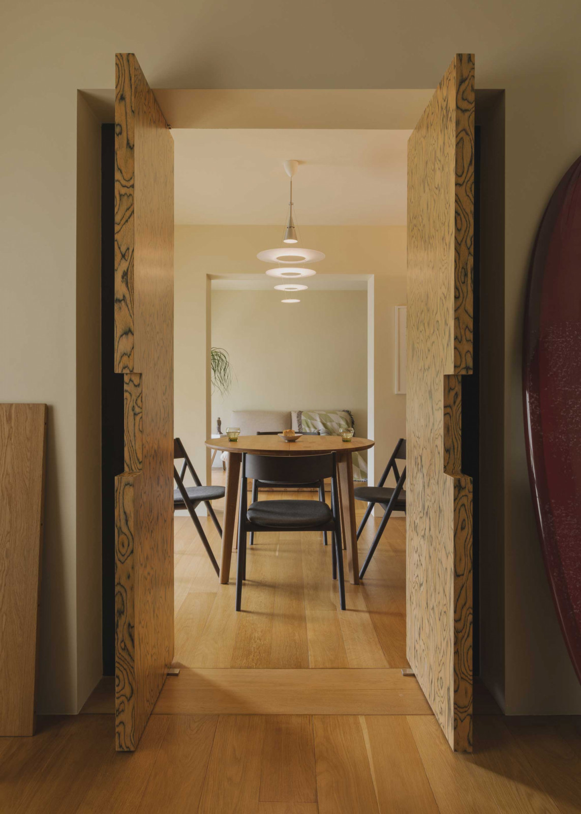 Custom veneer-clad French doors lead from the study to the dining area