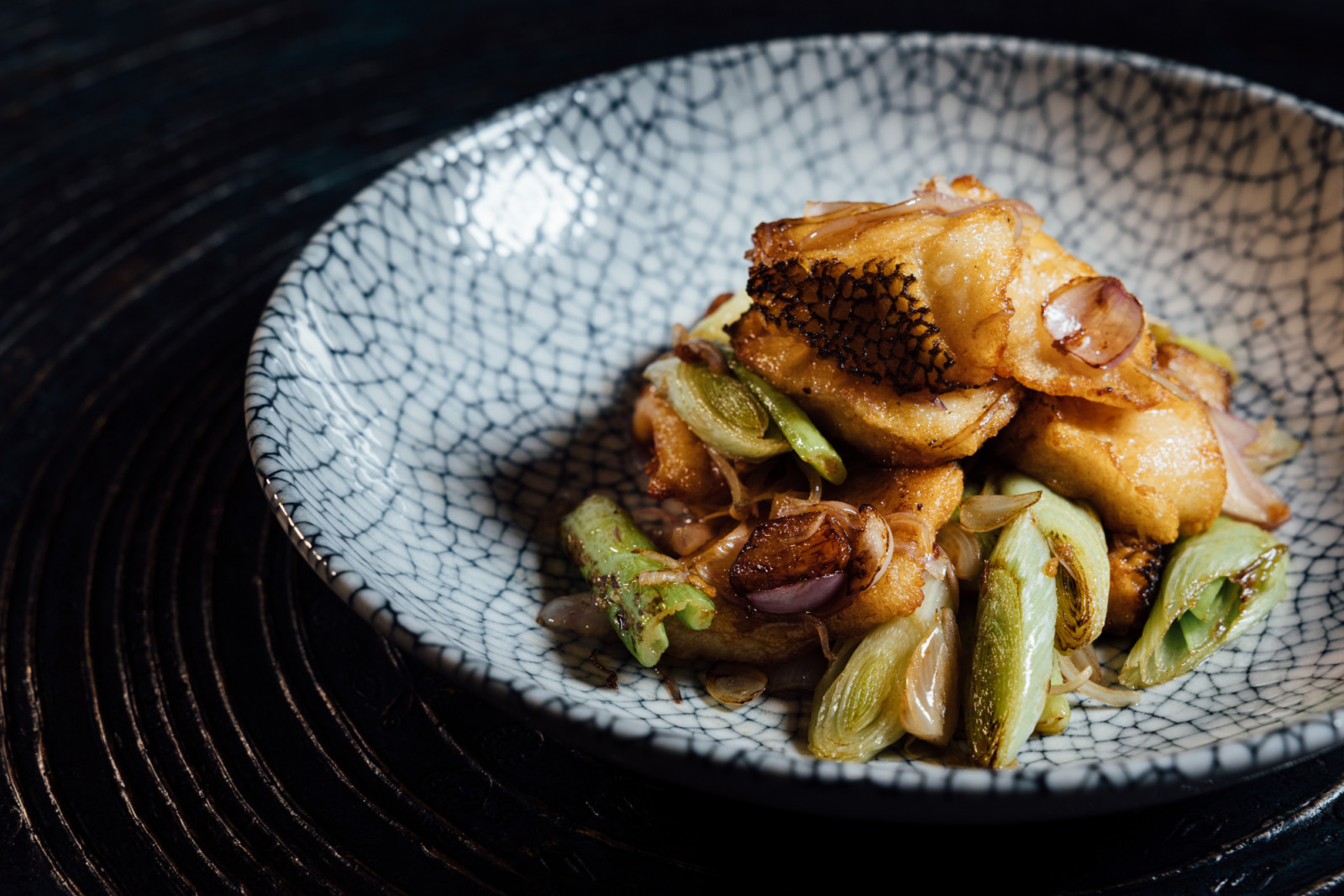 Cod fish with leek, shallot, scallion and soy sauce at Mott 32 Cebu