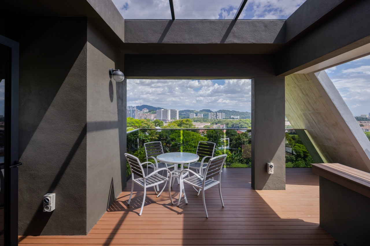 A seating area on the roof deck overlooks the neighbourhood toward the hills beyond