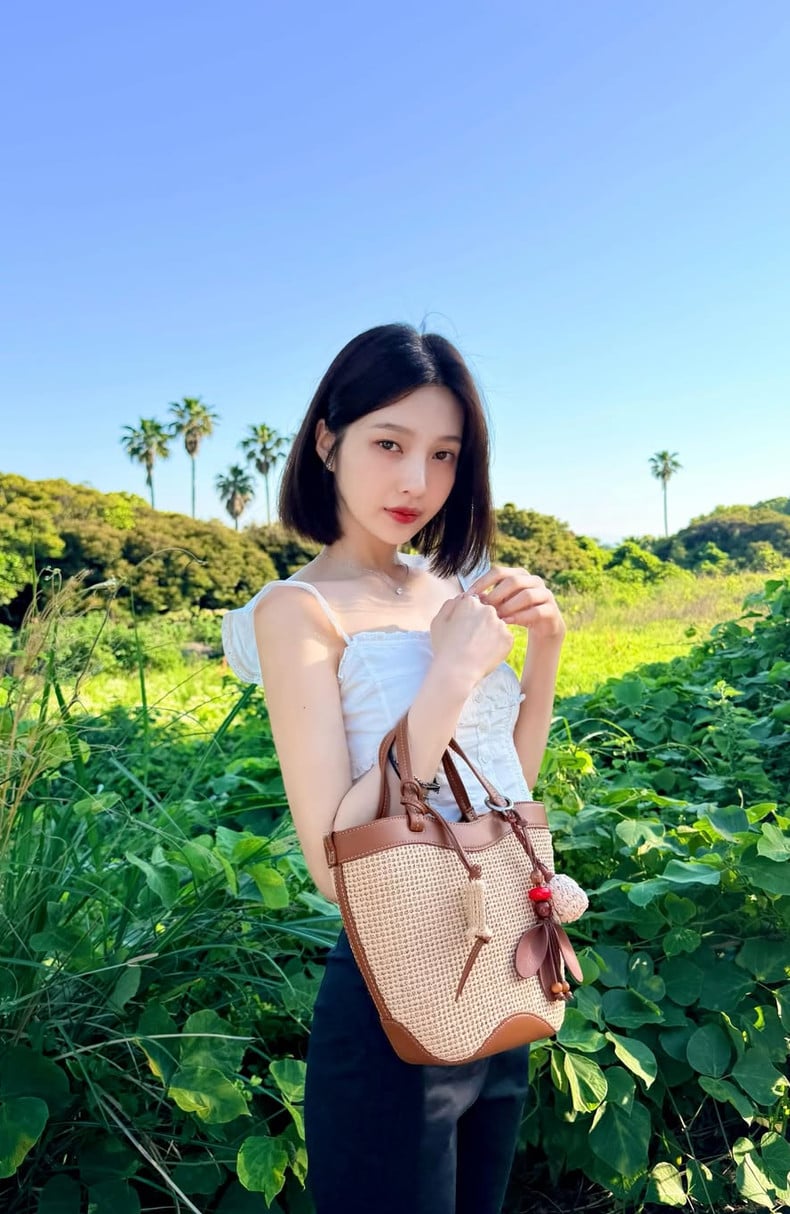 Red Velvet's Joy poses in a vibrant natural setting.