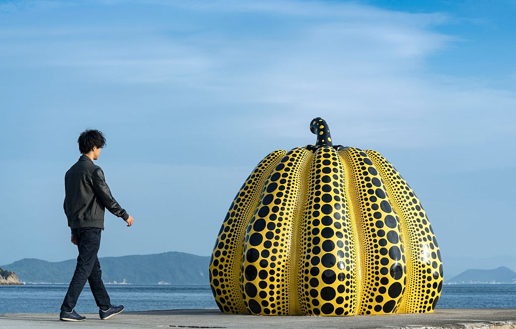 Japanese Tourist and Yellow Pumpkin of Kusama Yayoi, Naoshima, Japan. (Photo by: Education Images/Universal Images Group via Getty Images)