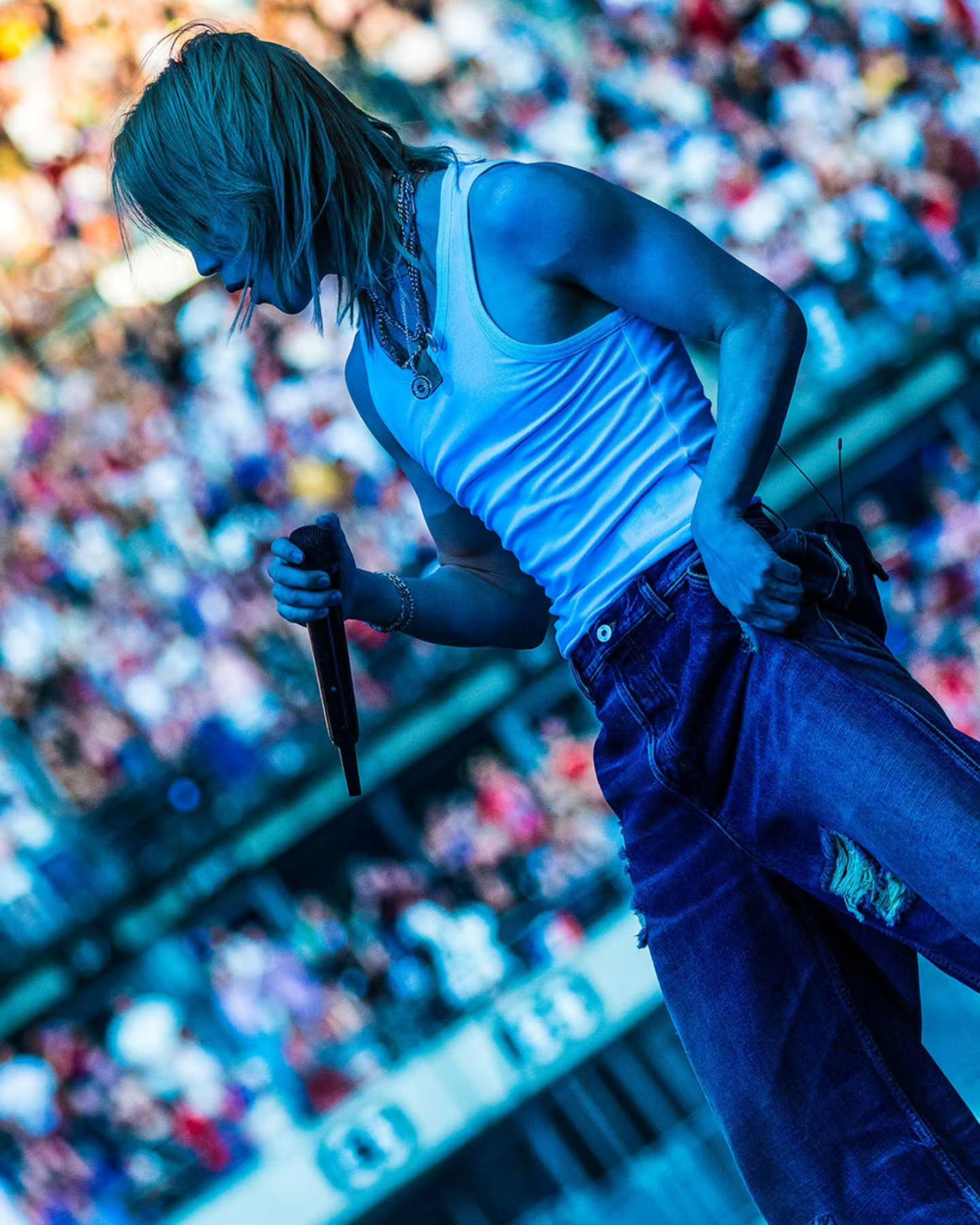 Jimin performs live, embodying the strength developed through his fitness regimen.