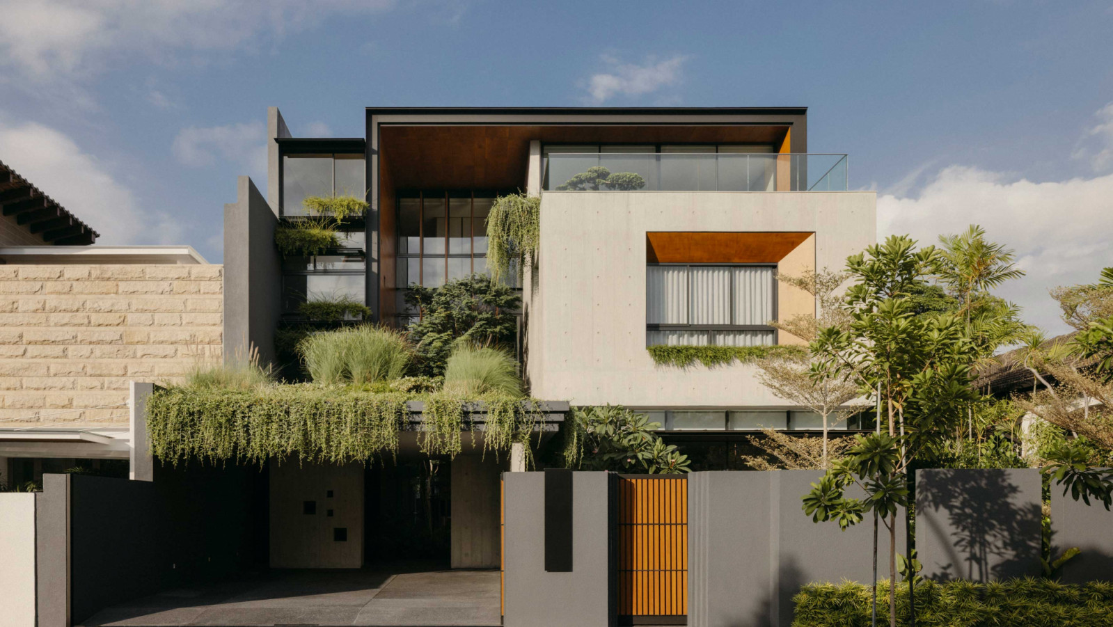 Evergreen House by AR43 Architects is a tropical semi-detached home in East Coast where rooms are organised around planted courtyards
