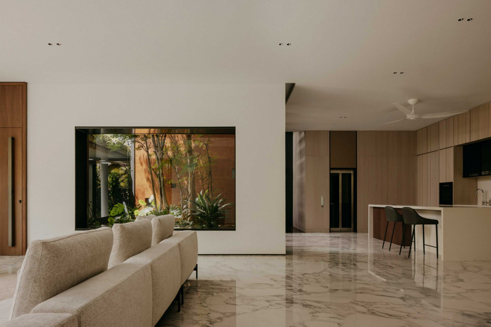 The courtyard, glimpsed through a window, is the heart of the home