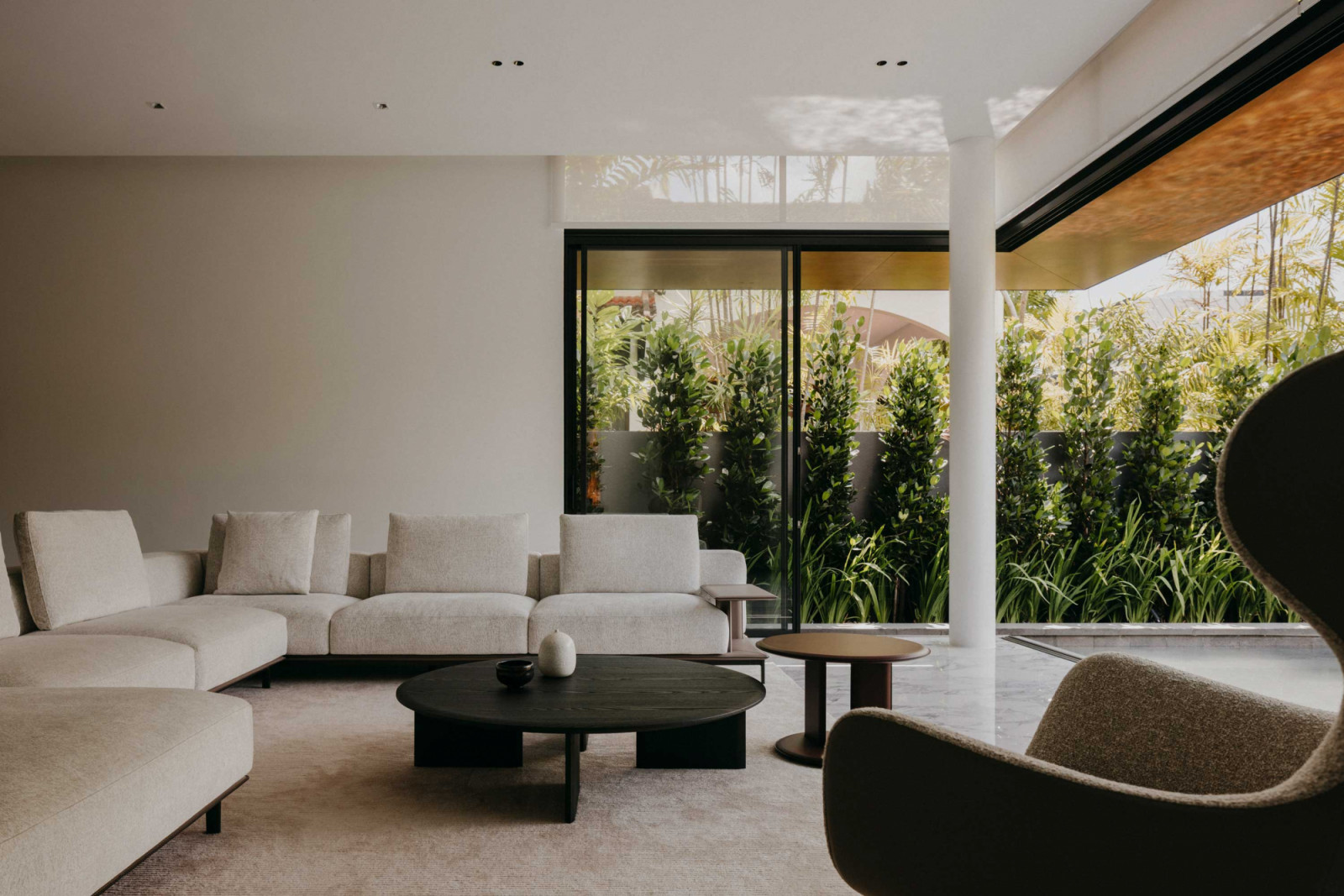 The expansive living room is grounded with pieces from Poliform, including the Mush coffee and side tables and Mad Joker swivel armchair