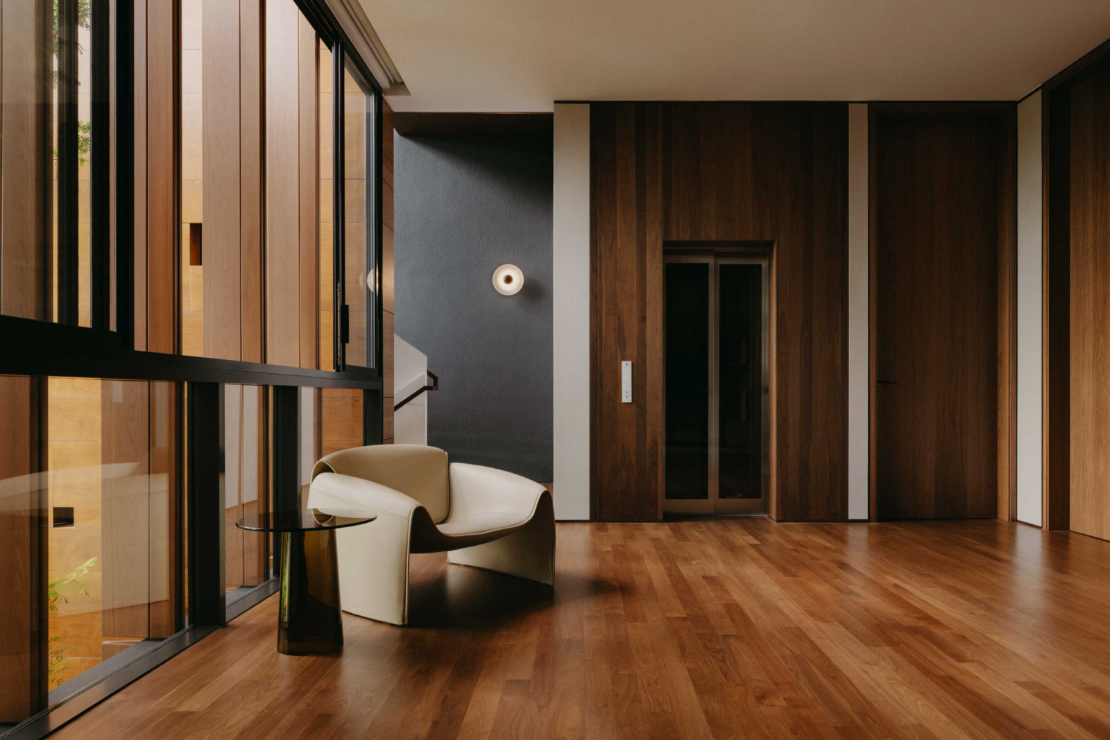 A Poliform Le Club armchair and Orbit side table hold court in this interstitial space