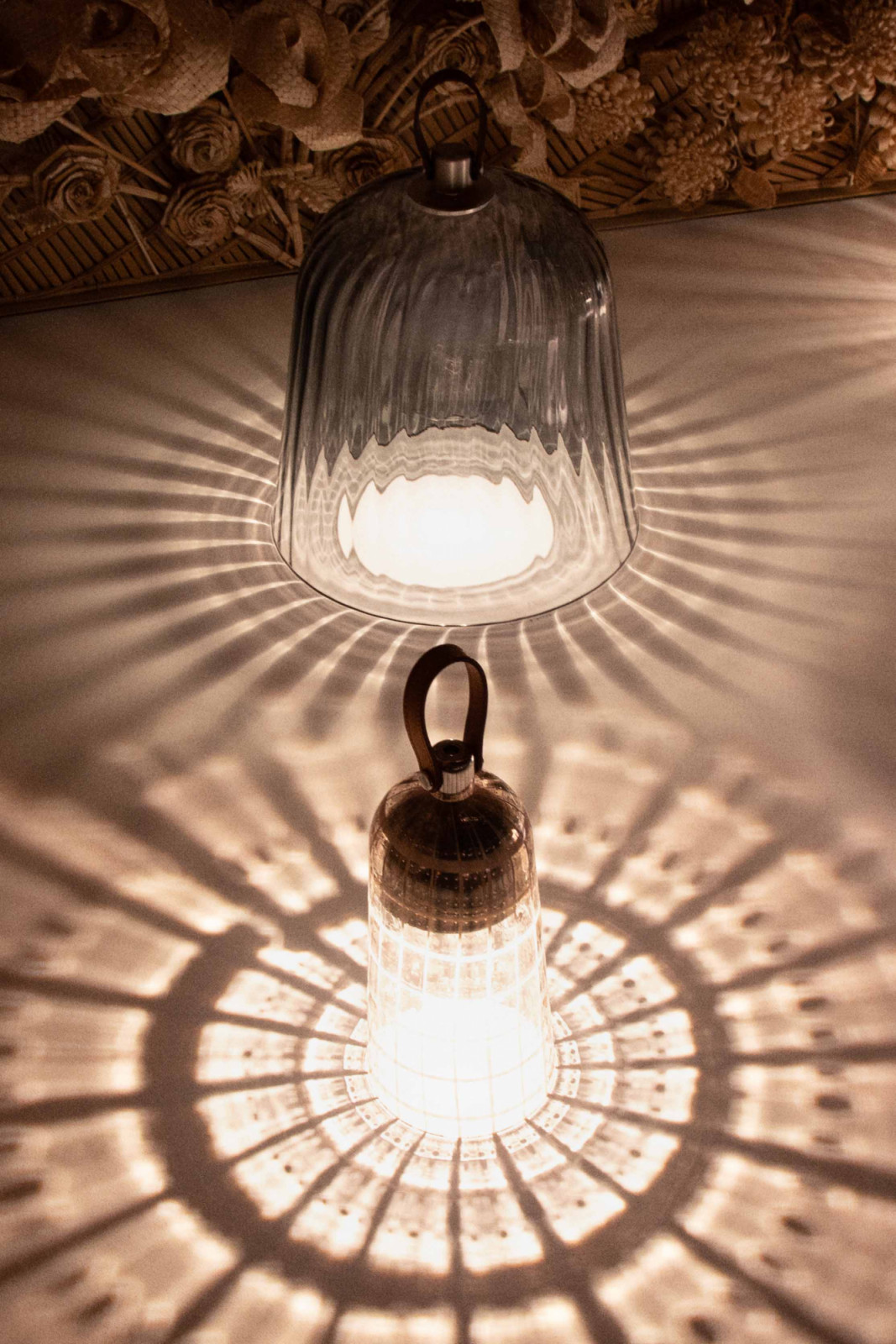 Two Corolle lamps in Murano glass casting their signature radial shadow patterns