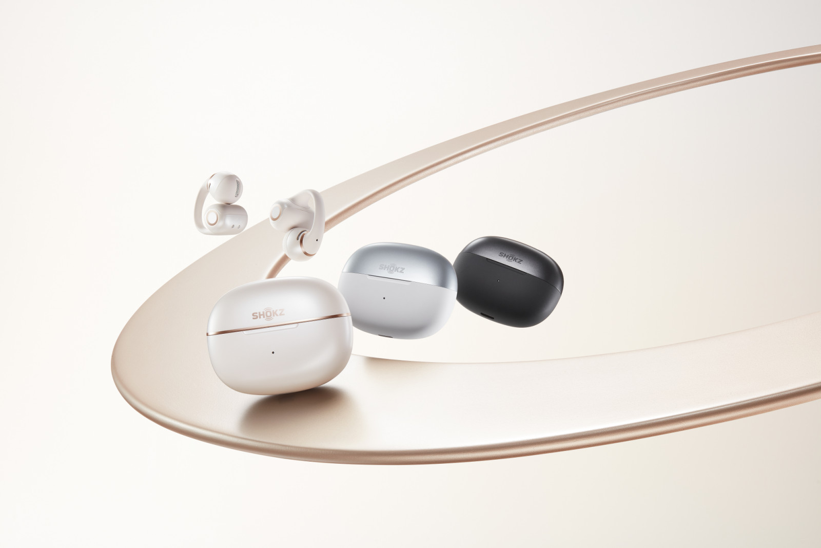 Shokz OpenDots 2 in three colourways: pearl white, grey and black