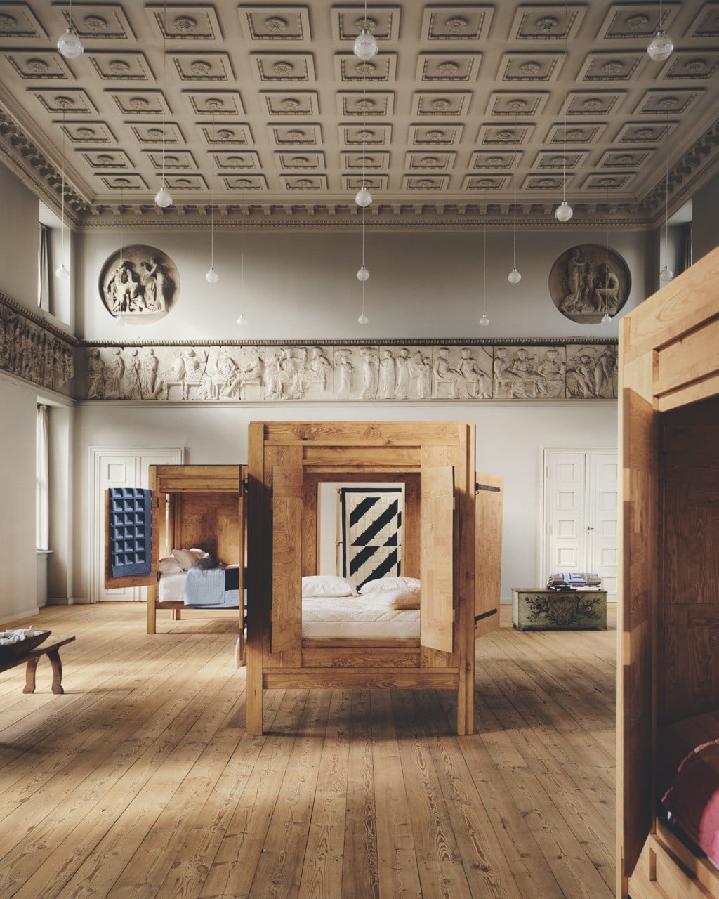Tekla’s The Heart  of Living exhibition featuring patchwork quilts and pine-box beds inspired by 19th-century Scandinavian cabin beds