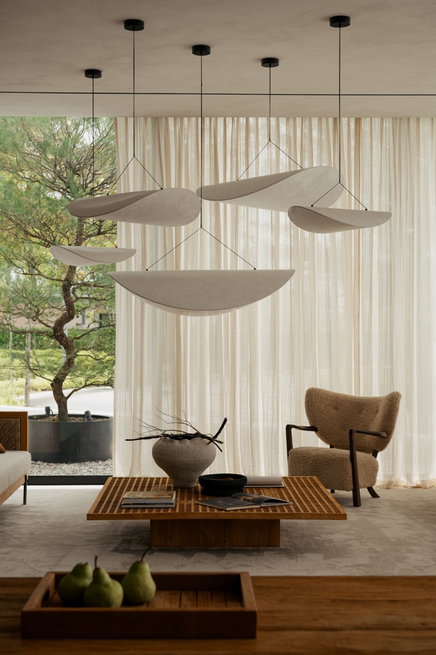 The same seating area, with a tray of pears on the low teak coffee table in the foreground