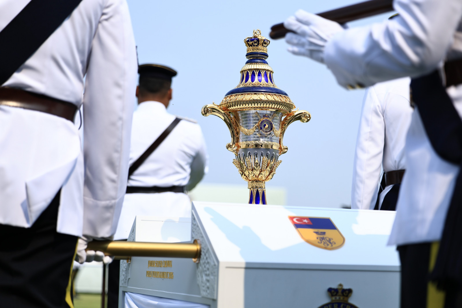 The Johor Militiary Force marches the official trophy to the presentation area during the prize presentation
