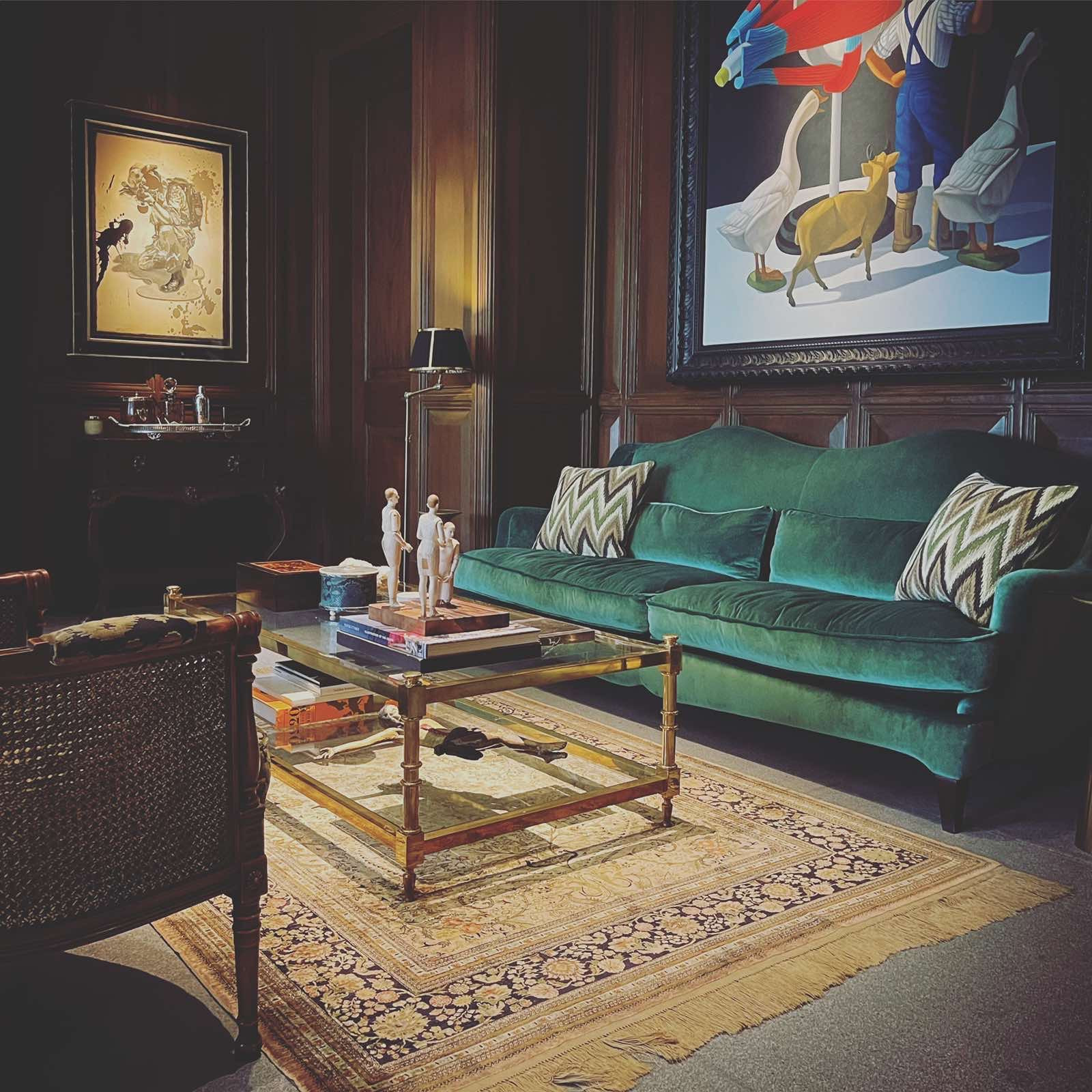 A den in a private collector’s residence, Artworks by leading Southeast Asian contemporary artists hang on antique wood-panelled walls, a custom silk velvet sofa by Pierre Frey