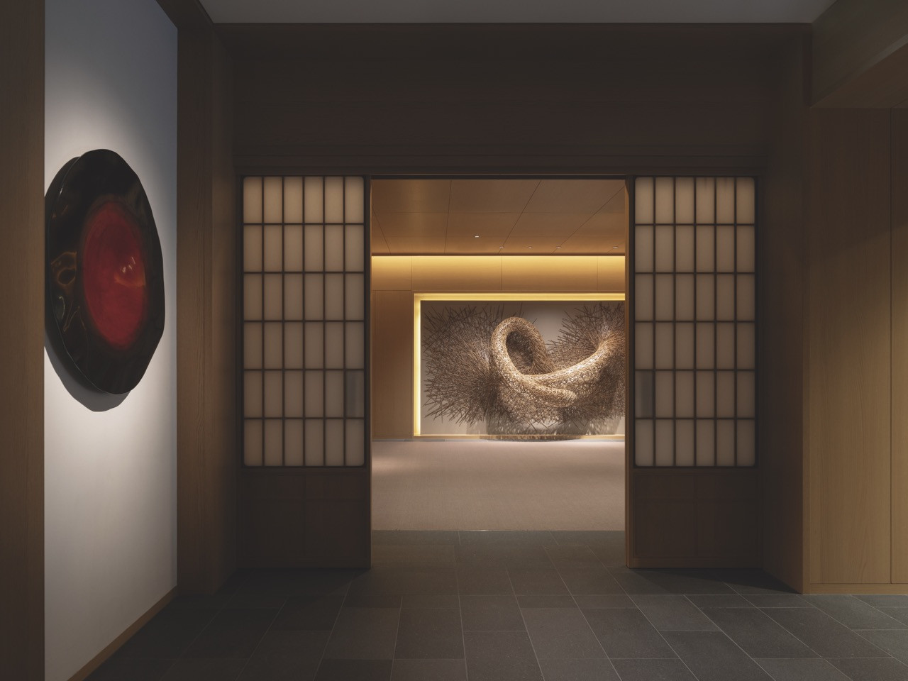 A view through shoji screens towards a large-scale bamboo sculpture from the hotel’s permanent collection of works by contemporary Japanese artists