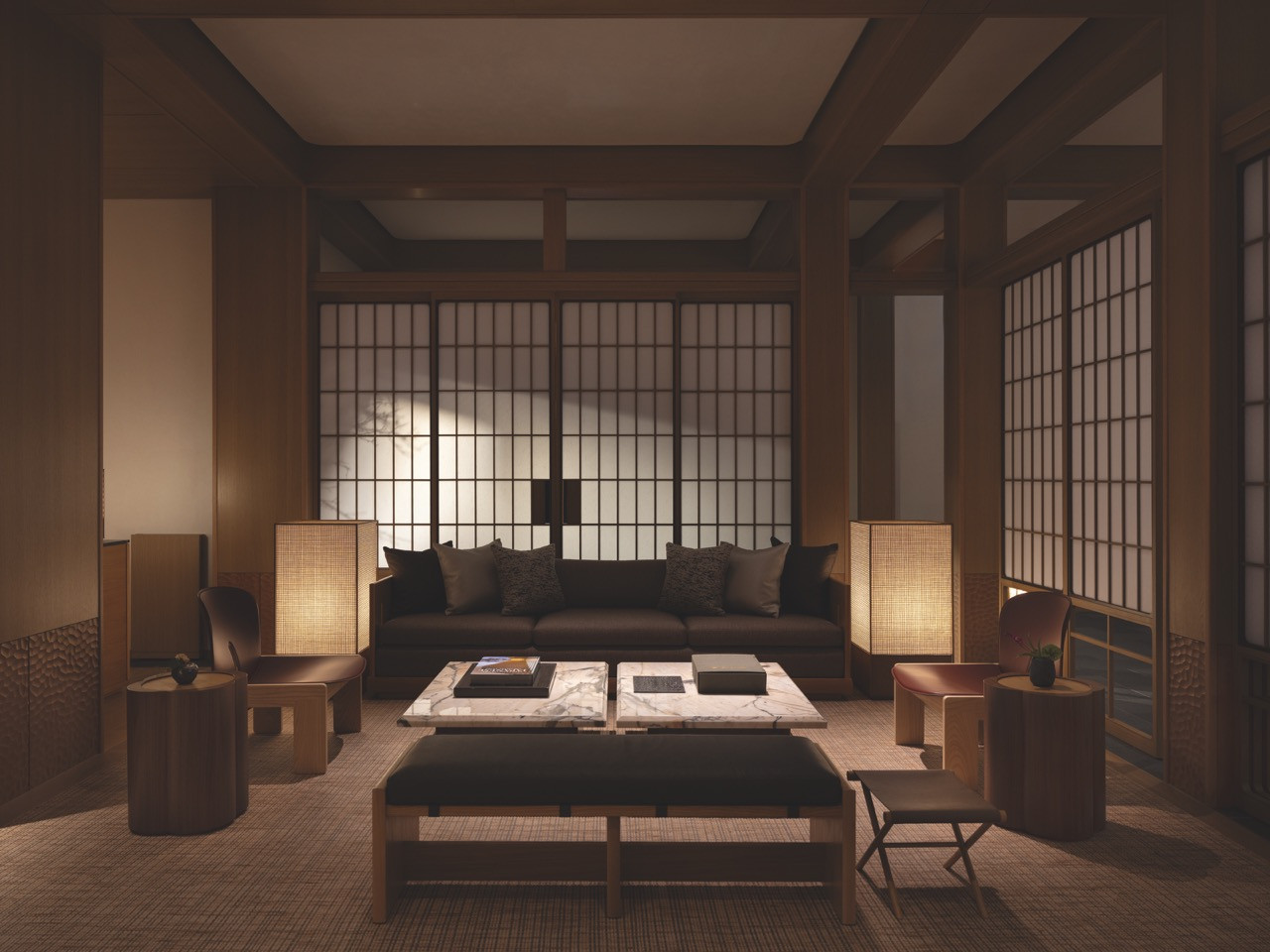 The Living Room at night, its custom woven-screen floor lamps casting a warm, low light