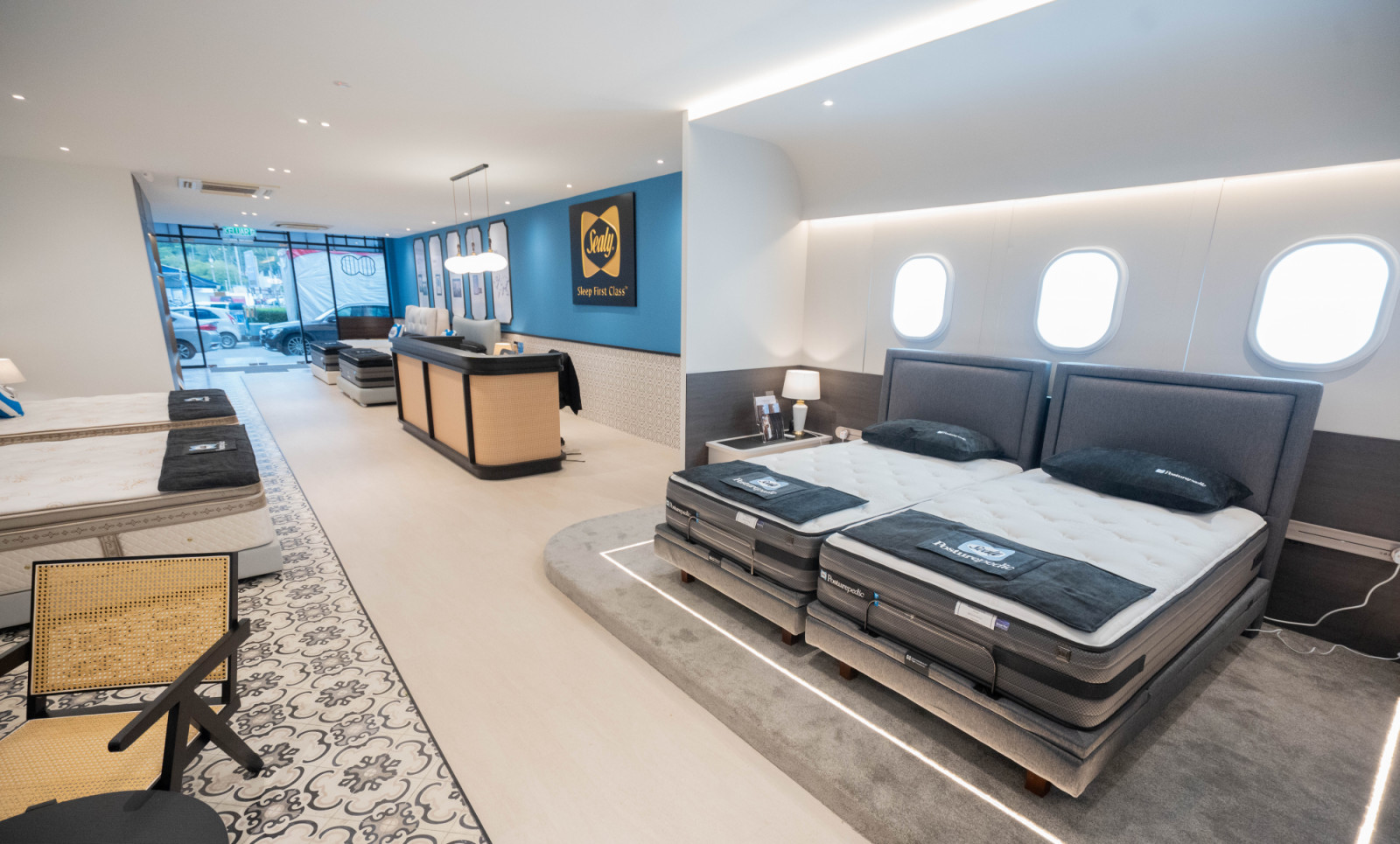 On the ground floor, the adjustable beds section reimagines Sealy’s “Sleep First Class” philosophy with illuminated aircraft-style windows, evoking the feel of a private cabin