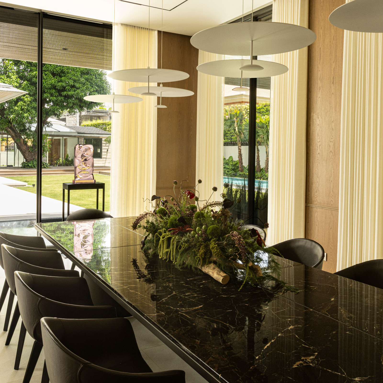 Dot 600 Lite suspension lamps from Lumina hang above a 12-seater
Kensington dining table in Saint Laurent marble top by Poliform with Poltrona Frau Ginger chairs in leather