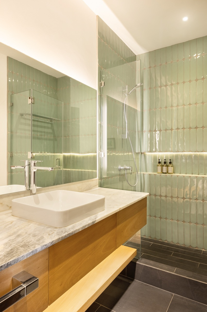 One of the home’s four bathrooms was fully modernised, with glazed green tile and a marble vanity top