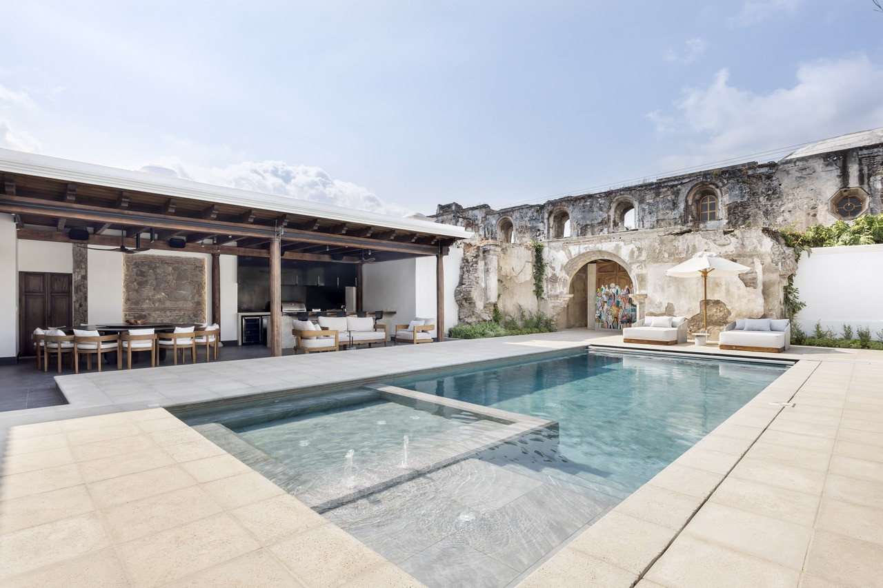 The pool runs alongside the ruined convent wall, with a painted door marking what was once believed to be the stables entrance