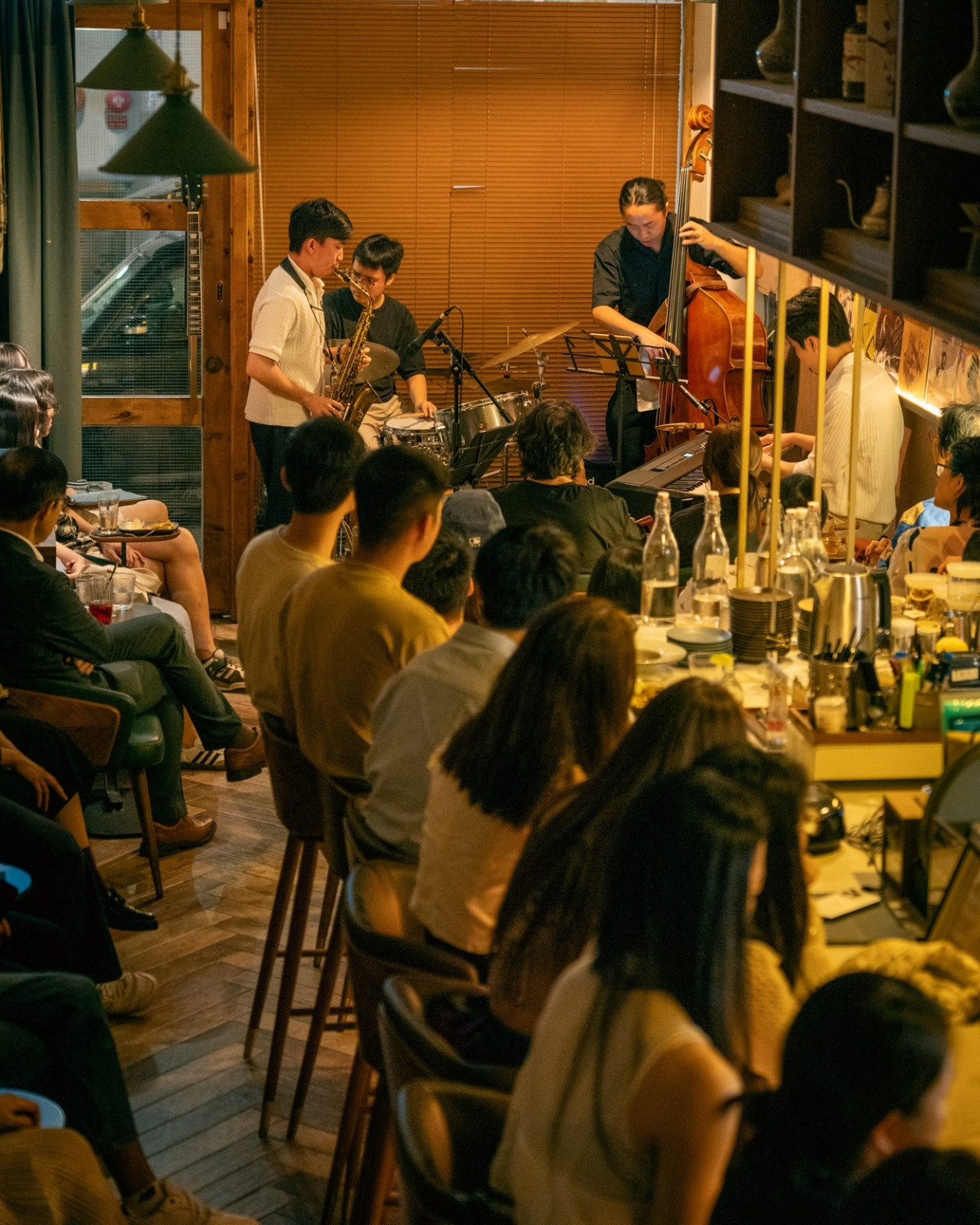 Guests gather at a stylish bar for an evening of live jazz music and cocktails.