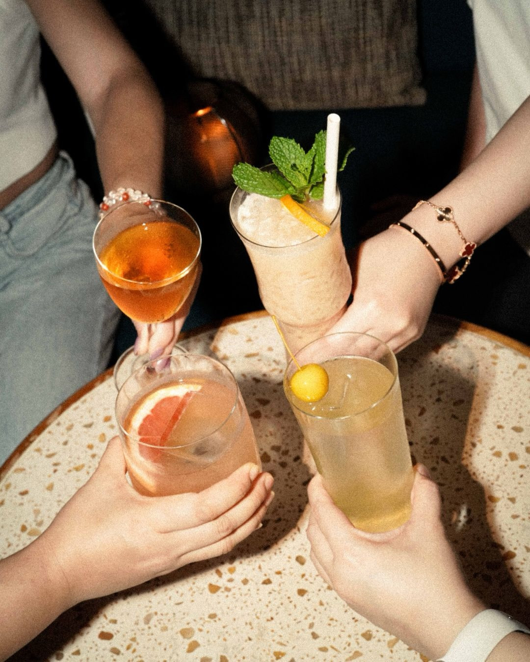 Friends toast with a selection of expertly crafted cocktails.