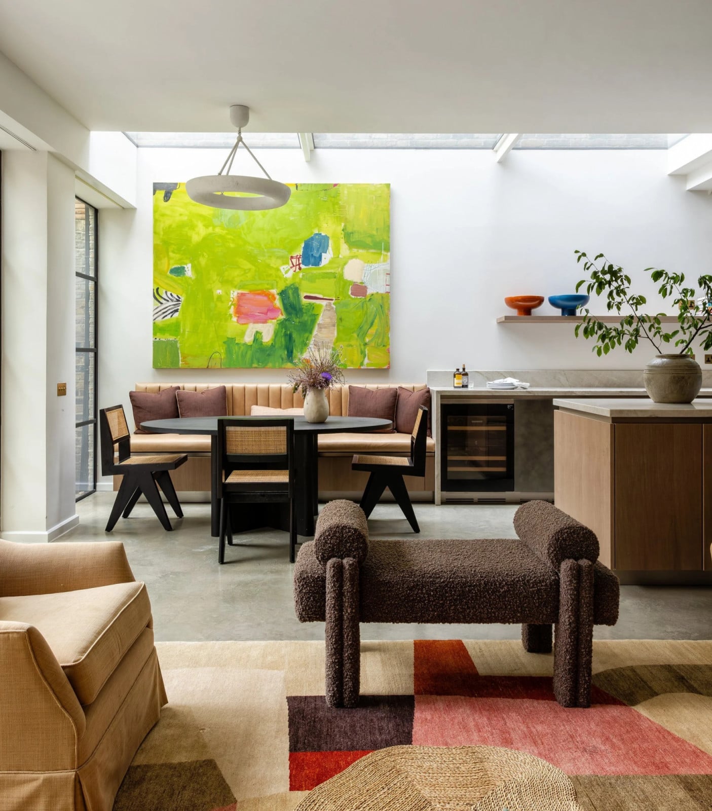A vibrant lime-green abstract artwork punctuates the breakfast nook